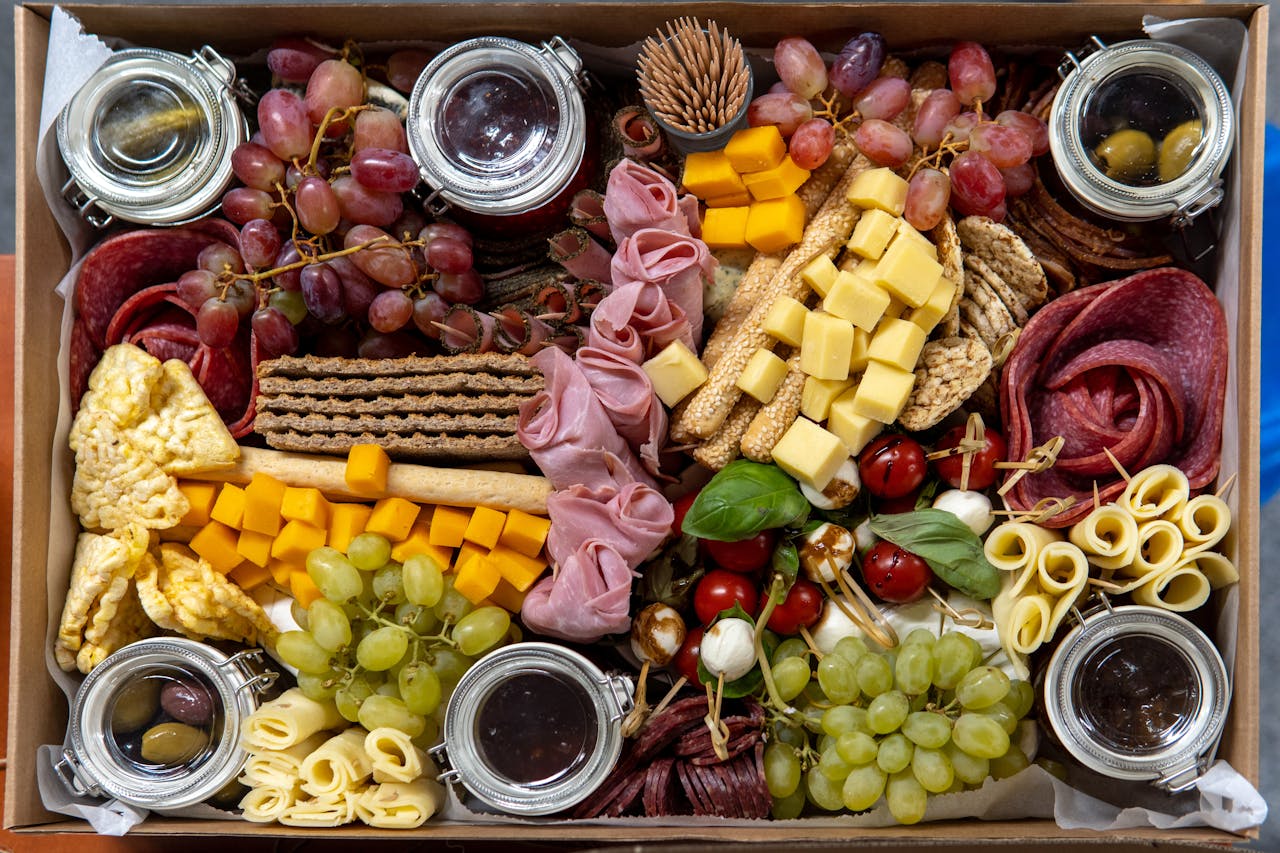 Elegant charcuterie board featuring a variety of cheeses, meats, fruits, and condiments.